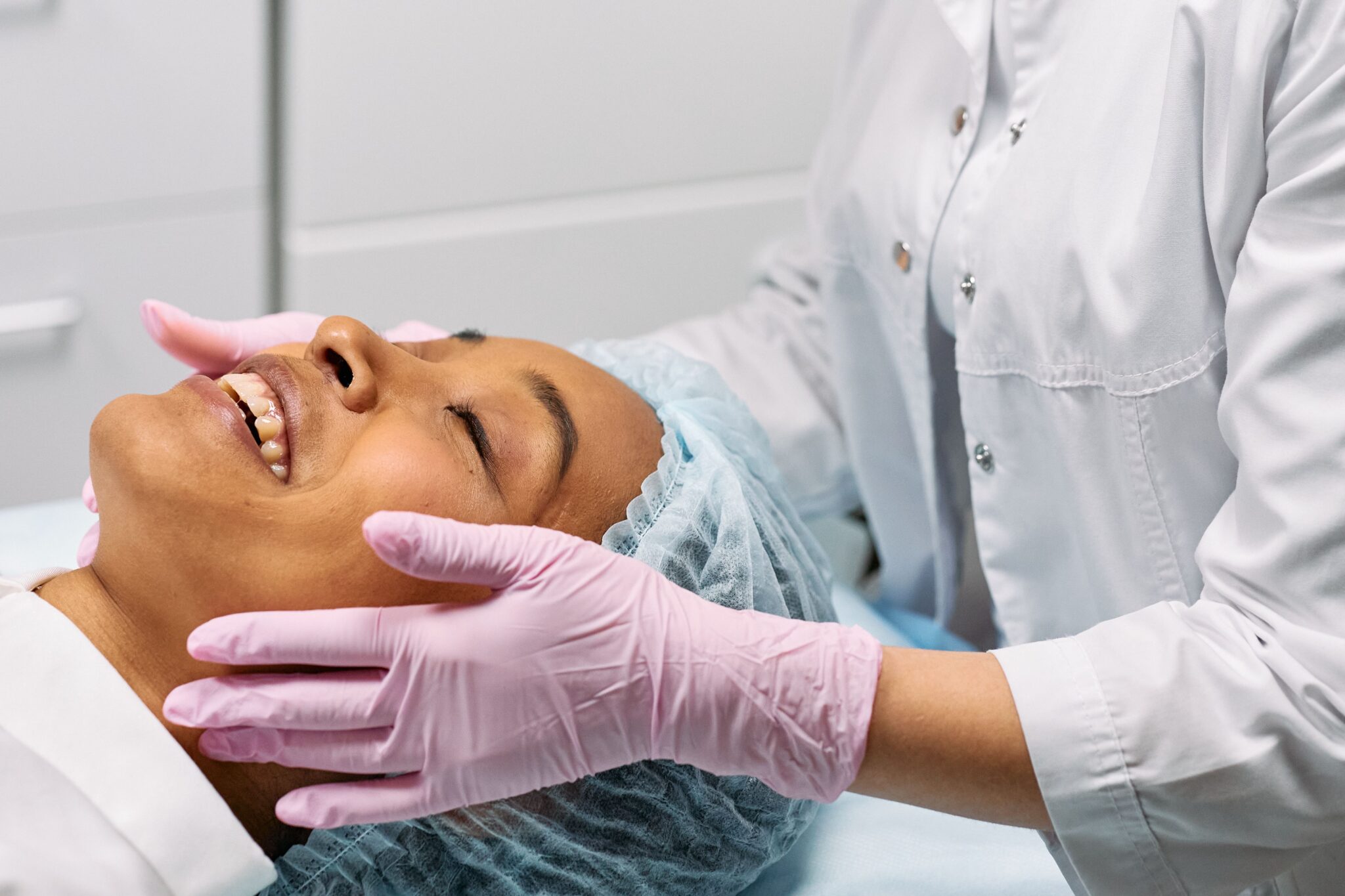 A client receiving a relaxing facial treatment at a modern spa clinic.